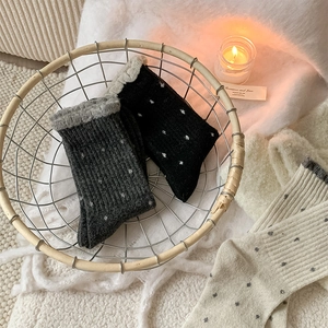 Cozy winter wool blend socks with polka dot pattern displayed in a warm home setting