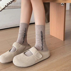 Women's ruffled wool blend crew socks in taupe with chic black wavy side patterns