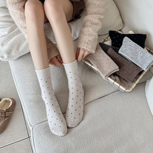 Close-up of cozy wool blend polka dot mid-calf socks in various soft autumn colors