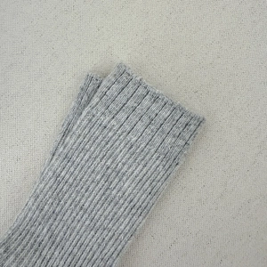Close-up of grey ribbed knit wool socks showing the detailed texture and soft elastic fabric