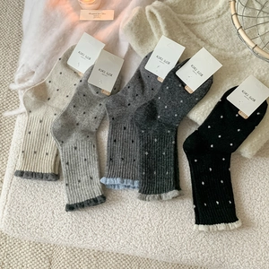 Detailed close-up of 5-pack wool blend polka dot socks with ruffled edges and warm knit texture