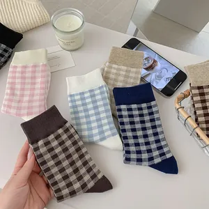 Detail view of plaid cotton crew socks in pastel colors with high-quality ribbed cuffs