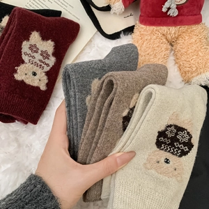 Detail showing thick wool socks with 3D flocked bear embroidery in assorted colors