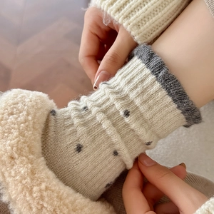 Detail of wool knit polka dot crew socks with thick warm fleece lining for winter wear