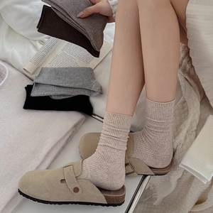 Close-up of ribbed knit socks in assorted neutral colors for a cozy autumn winter style
