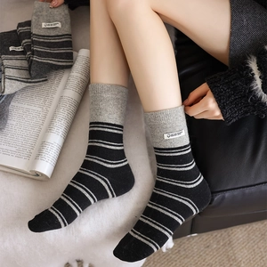 Close-up of knit striped socks with a fabric label and cozy cotton texture detail