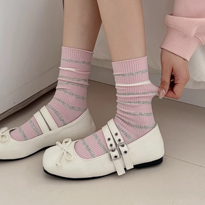 Pink and grey striped mid-calf socks paired with stylish white Mary Jane shoes