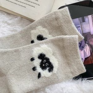 Détail de chaussettes en laine avec motif mouton mignon et texture tricotée confortable