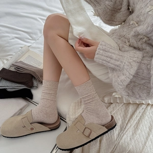 Vertical ribbed cotton socks in neutral tones styled with khaki buckle mule shoes