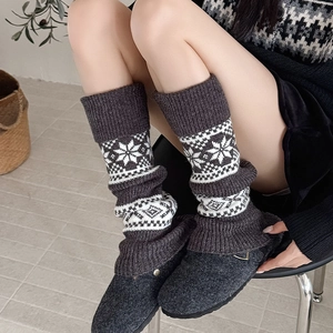 Detail of dark grey Fair Isle leg warmers with snowflake knit pattern and ribbed cuffs