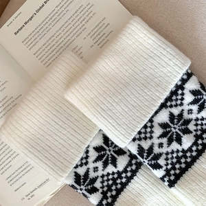 Detailed view of Fair Isle snowflake pattern on thick warm knitted leg warmers
