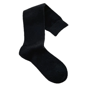 Thick black knitted calf socks with ribbed cuffs in a minimalist retro style