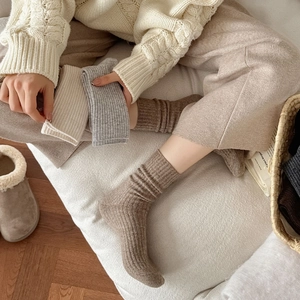 Close-up of thick ribbed knit wool socks in beige and grey for winter warmth