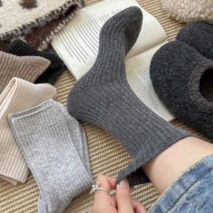 Detailed ribbed knit texture of thick wool socks in minimalist neutral autumn colors