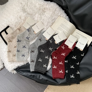 Detailed set of six wool blend mid-calf socks with bow patterns in assorted autumn colors