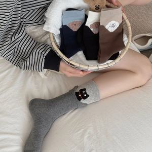 Detailed view of cute 3D embroidered animals on cotton crew socks in neutral colors