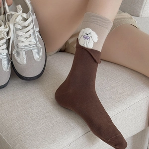 Detailed knit of brown crew socks with cute white puppy and purple bow embroidery