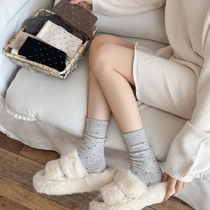 Detail of wool knit polka dot mid-calf socks set showing ribbed texture and soft colors