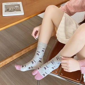 Detailed view of light gray mid-calf socks featuring cute black dog prints and pink bow details