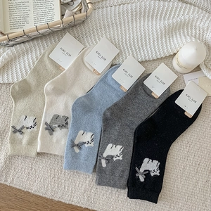 Detailed flat lay of five colors of wool blend cat socks with bow and embroidery