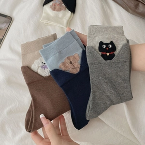 Detailed view of cute embroidered animal patterns on soft cotton crew socks in multiple colors