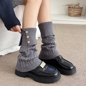 Detail of grey cable knit leg warmers with vintage wood buttons and ribbed cuffs