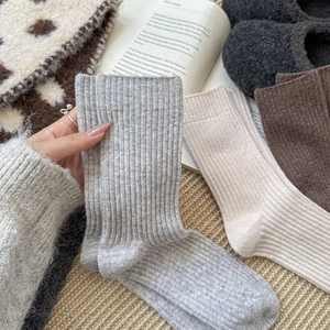 Detailed knit texture of thick wool blend mid-calf socks in earthy autumn colors