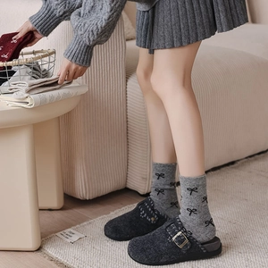 Thick wool socks with bow patterns paired with grey buckled felt clogs for autumn