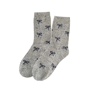 Thick warm wool crew socks in light grey with navy blue bow jacquard patterns