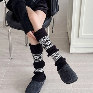 Fair Isle knit leg warmers in black and white snowflake pattern for winter comfort