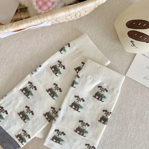 Cute Japanese style crew socks featuring brown cartoon puppies on a cream knit fabric