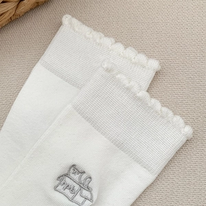 Detailansicht weißer Baumwollsocken mit süßer Katzenstickerei und Volant-Abschluss