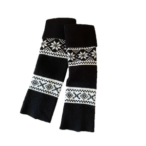 Fair Isle pattern knit leg warmers with snowflake motifs and ribbed cuffs for winter