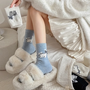Detail of wool knit mid-calf socks with cute cat patterns and plaid bows for women