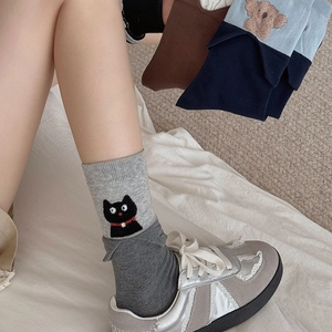 Close-up of cute animal embroidery and ribbed cuffs on cotton mid-calf socks