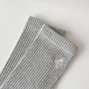 Detail of grey ribbed mid-calf sock with white cactus embroidery and soft knit texture