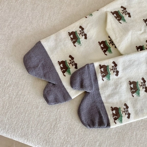 Close-up of Tabi socks with cute cartoon dog pattern and ribbed knit texture details