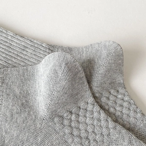 Detailed macro view of the grey cotton knit heel with reinforced stitching and non-slip texture