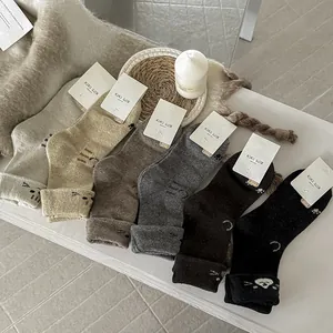 Close-up of 6-pair pack thick cartoon cat patterned thermal wool crew socks in earth tones