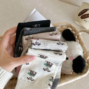 Close-up of soft cotton socks with cute cartoon animal patterns in earthy tones