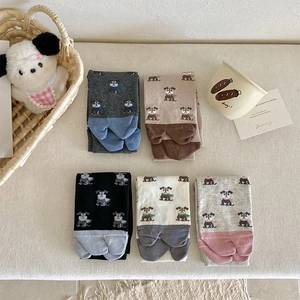 Detailed flat lay of five pairs of cotton cartoon dog socks in neutral assorted colors