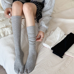 Ballet style two-toe knit calf socks in grey, white, and black with ribbed cuffs