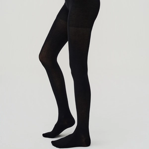 Close-up of matte black tights with fine knit texture and slim fit elastic fabric