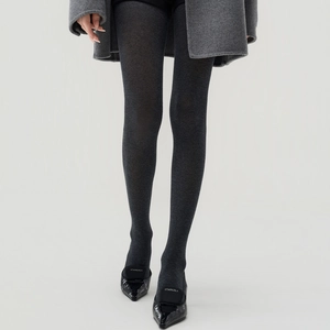 Close-up of high-quality dark grey thermal tights with dense knit texture and slim fit