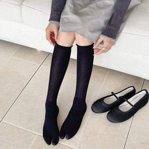 Detail shot of black Tabi socks with split-toe design and seamless cotton texture