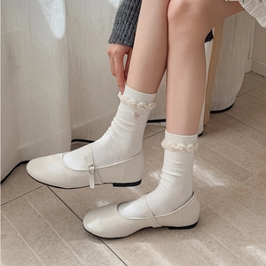 White Mary Jane shoes with ruffled trim crew socks featuring pink heart embroidery detail