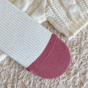 Macro detail of ribbed knit cotton socks with contrast color toes and soft winter texture