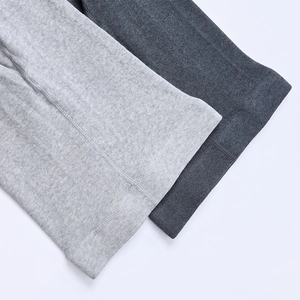 Detailed macro view of gray knitted fabric texture and fine stitching on leggings