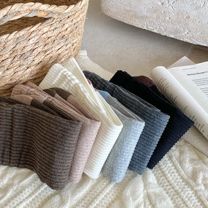 Detailed pile of assorted ribbed knit crew socks in warm earth tones and neutral colors