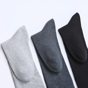 Detailed ribbed texture of cotton mid-calf socks in light grey, dark grey and black